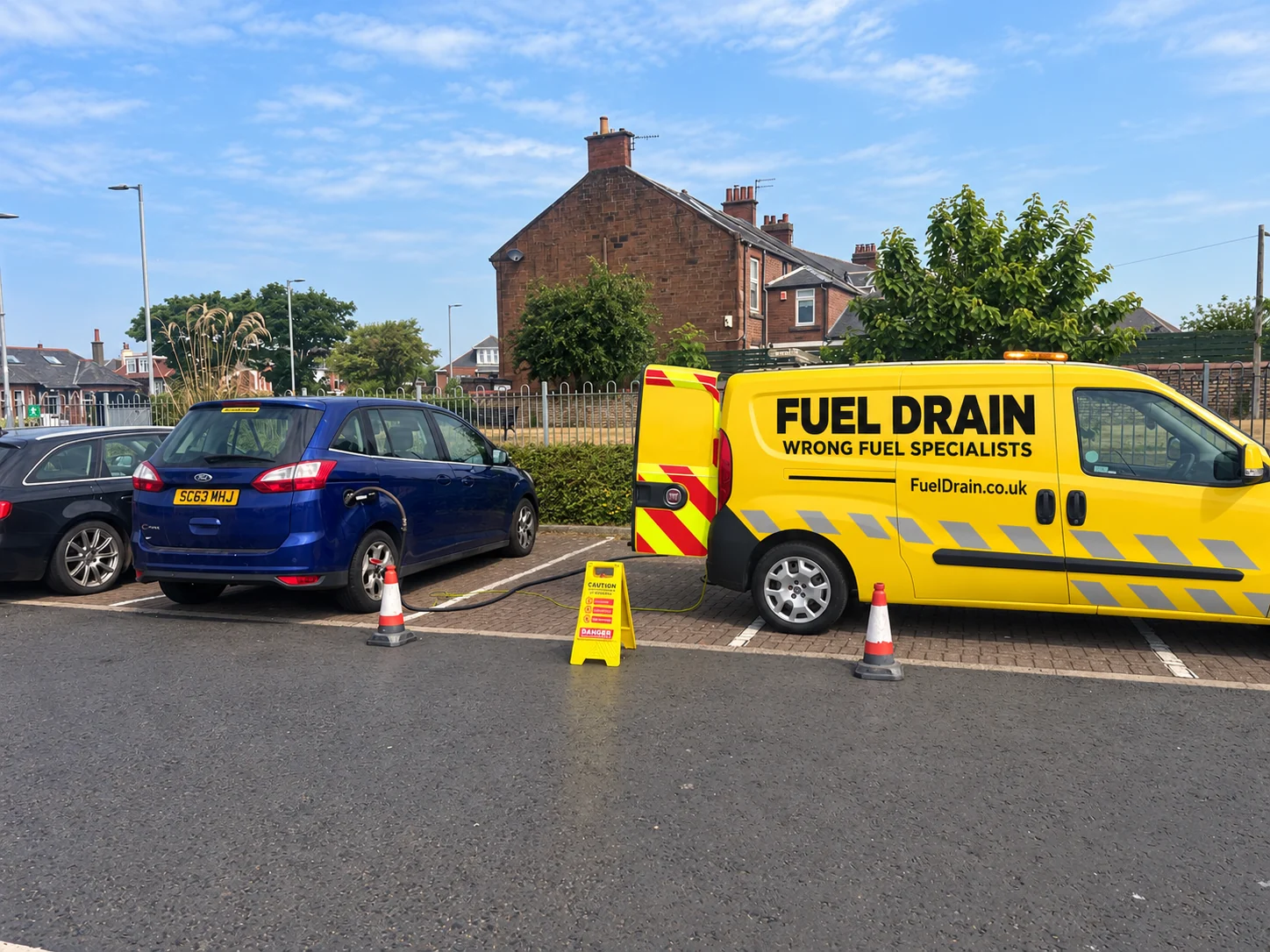 Fuel Drain van beside a customer vehicle